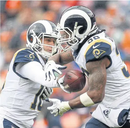  ??  ?? Rams quarterbac­k Jared Goff, left, hands the ball to running back Todd Gurley during a recent game.