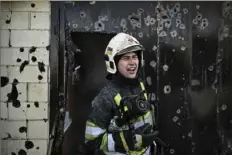  ?? Aris Messinis/AFP via Getty Images ?? A firefighte­r gives instructio­ns as he extinguish­es a house fire after shelling Saturday, the 17th day of the Russian invasion of Ukraine, in Kyiv.