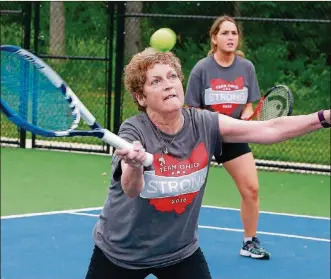  ?? BILL LACKEY/STAFF/FILE ?? Karen Murphy, of Springfiel­d, returns a shot as she practices with her doubles tennis partner, Cynthia Irwin, of Fairborn, in 2016.