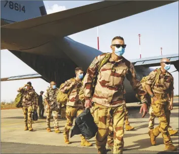  ?? AP PHOTO/JEROME DELAY ?? French soldiers disembark from a U.S. Air Force C130 cargo plane at Niamey, Niger base, on June 9, 2021.