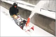  ?? Ned Gerard / Hearst Connecticu­t Media ?? Eddie Terron, of Stamford, uses a snowblower Saturday morning in Bridgeport.