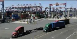  ?? MARCIO JOSE SANCHEZ — THE ASSOCIATED PRESS FILE ?? Trucks travel along a loading dock at the Port of Long Beach in Long Beach. The U.S. economy grew at a robust annual rate of 3.5 percent in the July-September quarter as the strongest burst of consumer spending in nearly four years helped offset a sharp drag from trade.