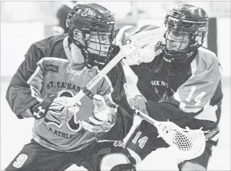  ?? JULIE JOCSAK TORSTAR ?? St. Catharines Kealon Pilon, left, keeps the ball away from Six Nations’ Owen Hill in Wednesday night junior A lacrosse quarter-final playoff action at Jack Gatecliff Arena in St. Catharines.