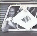  ?? UPI ?? A newly liberated American serviceman waves a hand-drawn flag from an ambulance window. U.S. prisoners of war began getting their release on Feb. 12, 1973, as part of Operation Homecoming.