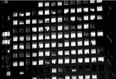  ??  ?? Office lightings are seen through windows of a high-rise office building in Tokyo. Japanese companies are warming to mobilising their mountains of accumulate­d cash for M&A but remain stubbornly resistant to wage increases, a Reuters poll showed on...