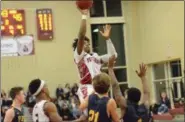  ?? THOMAS NASH - DIGITAL FIRST MEDIA ?? Pottsgrove’s Manny Clark rises above a couple Pope John Paul II defenders for a jump shot during Friday night’s game.