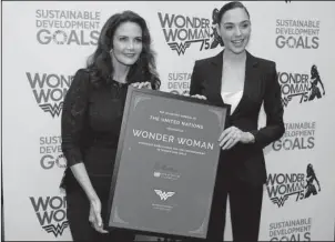  ?? The Associated Press ?? EMPOWERING WOMEN: Actress Lynda Carter, who starred in the 1970s series,”Wonder Woman,” left, and actress Gal Gadot, who stars in the upcoming film, “Wonder Woman,” appeared on Friday at a United Nations event naming the super hero character as an...