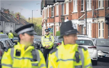  ?? Picture: PA. ?? Police in Harlesden Road, London, after a woman in her twenties was shot by officers during a raid on a home in the street.