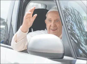  ?? Gregorio Borgia The Associated Press ?? Pope Francis waves from his car as he leaves the Agostino Gemelli University Hospital in Rome on Saturday after receiving treatment for bronchitis, The Vatican said.