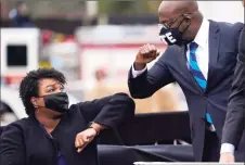  ?? Tribune News Service ?? U.S. Democratic Sen.-elect Raphael Warnock, right, bumps elbows with Stacey Abrams during a campaign rally with U.S. President-elect Joe Biden in Atlanta last month.