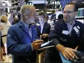  ?? RICHARD DREW — THE ASSOCIATED PRESS FILE ?? Trader Timothy Nick, left, and specialist Anthony Matesic work on the floor of the New York Stock Exchange.