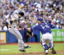  ?? FRANK GUNN — THE CANADIAN PRESS VIA AP ?? Toronto Blue Jays catcher Russell Martin (55) reaches for Tampa Bay Rays’ Steven Souza Jr. (20) in a rundown during the third inning of Tuesday’s game. Tampa Bay won 8-1.