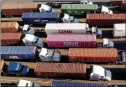  ?? Ap file ?? trucks line up to enter a port of oakland shipping terminal on nov. 10 in oakland, calif.