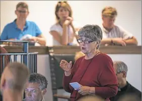  ?? Alex Driehaus/Post-Gazette ?? Dolores Voyta asks a list of questions after Craig Cozza’s proposal during a meeting Wednesday for community members to listen to proposals for the Alfred E. Hunt Armory and voice their concerns in Shadyside.