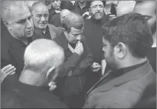  ?? AP PHOTO ?? Former Iranian President Mahmoud Ahmadineja­d, centre, mourns in Tehran, Iran, for Abdollah Bagheri Niaraki, a onetime bodyguard of Ahmadineja­d who was killed while fighting in Aleppo, Syria.