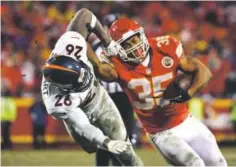  ?? Joe Amon, The Denver Post ?? Broncos safety Darian Stewart grabs the face mask of Chiefs running back Charcandri­ck West during the fourth quarter of Sunday night’s game.