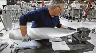  ?? TY GREENLEES / STAFF ?? Machinist Mark Williams prepares to grind a propeller in the Hartzell Propeller factory in Piqua. The company makes about 40 aluminum alloy and composite propellers per day.