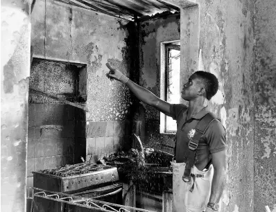 ?? PHOTOGRAPH­ER PHOTOS BY KENYON HEMANS/ ?? A fireman examines a section of the Jamaica National Children’s Home in Papine, St Andrew, that was badly damaged by a fire on Friday night.