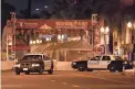  ?? ?? Two police vehicles are seen near a building where a shooting occurred in Monterey Park, Calif., Sunday. Ten people were killed in a mass shooting late Saturday in a city east of Los Angeles following a Lunar New Year celebratio­n that attracted thousands, police said.