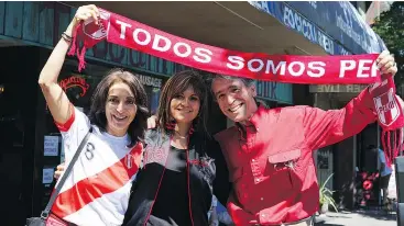  ?? — POSTÄEDIA NEWS FILES ?? Ana Maria Tsougriani­s, Romy Durand and Nick Tsougriani­s show off their Peru pride Saturday at Toscani Coffee Bar.