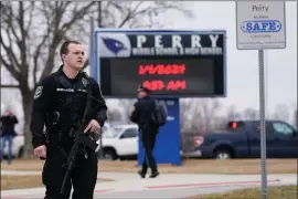  ?? ANDREW HARNIK, FILE - THE ASSOCIATED PRESS ?? Police respond to Perry High School, Jan. 4, in Perry, Iowa. Iowa’s Republican-led Legislatur­e passed a bill this week allowing teachers and staff who undergo training to get permits to carry guns on school property. That comes three months after a fatal shooting at the Iowa school.