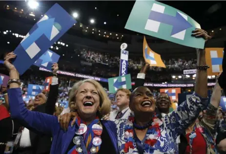  ?? JIM YOUNG/REUTERS ?? Delegates celebrate after Hillary Clinton won the Democratic presidenti­al nomination in Philadelph­ia on Tuesday.