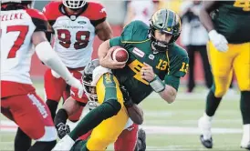  ?? JASON FRANSON THE CANADIAN PRESS ?? Soon-to-be free agent, Edmonton Eskimos quarterbac­k Mike Reilly, runs the ball. The new American league could attract some star CFL players, observers say.