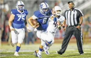  ??  ?? MacArthur quarterbac­k Austin Lee scrambles for yardage in the first half of Friday’s game.