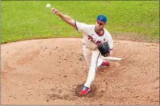  ?? CHRIS SZAGOLA/AP PHOTO ?? Philadelph­ia Phillies starting pitcher Zack Wheeler throws a pitch during the third inning of Sunday’s game against the New York Mets.