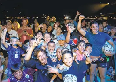  ?? DENIS POROY FOR THE U-T ?? Fans cheer at an event held to unveil San Diego’s MLS team’s new name, logo and colors outside Snapdragon Stadium on Friday evening. The new franchise, which will begin play in 2025, unveiled four versions of the logo, shown below.