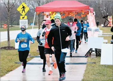  ?? JEFF VORVA/DAILY SOUTHTOWN PHOTOS ?? The first of six heats in the Orland Park Turkey Trot gets started on Sunday. To help prevent the spread of the coronaviru­s, the 2020 Trot was not the usual massive one-heat race on the morning of Thanksgivi­ng. Instead, the 32nd running of the race was a six-flight event that took place Sunday near Village Hall, and 296 runners finished the race compared to 844 in 2019.