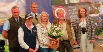  ?? ?? Mike Swan (second from right) presented Lorry Roberts with her award at the Welsh Game Fair