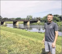  ?? MARK FISHER/STAFF ?? Toxic Brew Company founder Shane Juhl stands on the 4.3 acre tract of land on the east side of the Great Miami River in Old North Dayton where he plans to build a 13,000 square-foot production brewery and tap room.