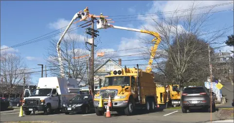  ?? Alexander Soule / Hearst Connecticu­t Media ?? Eversource technician­s work on lines this week in Norwalk.