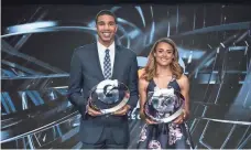  ??  ?? Jayson Tatum, left, and Sydney McLaughlin show off their Gatorade Athlete of the Year awards in Los Angeles. TRENT MUSHO, GATORADE