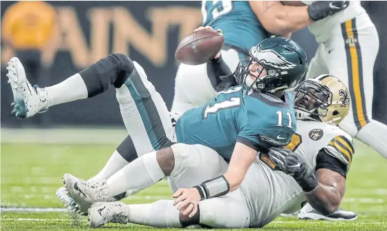  ??  ?? Eagles quarterbac­k Carson Wentz, No.11, is sacked by the Saints’ Sheldon Rankins during their game last week.