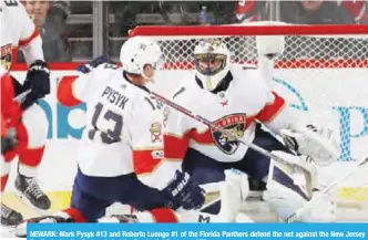  ??  ?? NEWARK: Mark Pysyk #13 and Roberto Luongo #1 of the Florida Panthers defend the net against the New Jersey Devils during the first period at the Prudential Center. —AFP