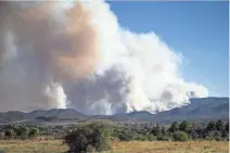  ?? TOM TINGLE/THE REPUBLIC ?? The heavy smoke from the Goodwin Fire as seen from the intersecti­on of 69 and 169 on Tuesday. The town of Mayer was later evacuated.