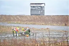  ?? — AFP photo ?? Flowers are placed at a site hit by the tsunami in Namie, Fukushima Prefecture on the eighth anniversar­y of the 2011 tsunami disaster.