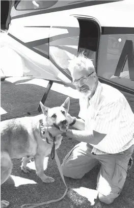  ?? Best Fur Friends Rescue via AP ?? Dr. Bill Kinsinger, a doctor volunteeri­ng for a dog rescue operation, poses with Jojo from Fort Worth Animal Care & Control in this Dec. 6 photo at a regional airport in northern Illinois.