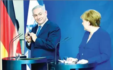  ?? TOBIAS SCHWARZ/AFP ?? German Chancellor Angela Merkel and Israeli Prime Minister Benjamin Netanyahu address a press conference after a meeting at the Chanceller­y in Berlin on Monday.