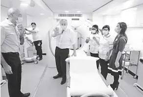  ?? Ian Vogler, Pool Photo VIA ap ?? Britain’s Prime Minister Boris Johnson, center, gestures during a visit to Finchley Memorial Hospital in north London on tuesday, January 18.