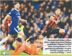  ??  ?? Bournemout­h striker Callum Wilson (right) leaps past Chelsea goalkeeper Thibaut Courtois after scoring his team’s first goal during yesterday’s English Premier League match at Stamford Bridge. –