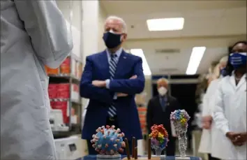  ?? Evan Vucci/Associated Press ?? President Joe Biden visits the Viral Pathogenes­is Laboratory at the National Institutes of Health on Feb. 11 in Bethesda, Md. Labeling the summer surge of virus cases “the pandemic of the unvaccinat­ed” hasn’t convinced many to get the vaccine.