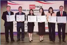  ?? ?? Officials from Feytech Holdings Bhd, TA Securities Holdings
Bhd and AmInvestme­nt Bank Bhd at the signing of the underwriti­ng agreement.