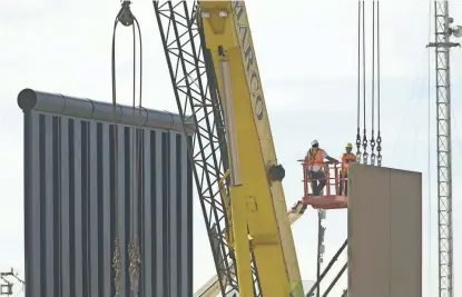  ?? DAVID WALLACE/THE REPUBLIC ?? Constructi­on of the border-wall prototypes takes place on Oct. 17 near the Otay Mesa Port of Entry in San Diego.