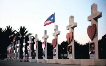  ?? PICTURE: AP ?? CROSSES TO BEAR - one for each victim, line a walkway as a memorial to those killed in the Pulse nightclub mass shooting a few blocks from the club early yesterday, in Orlando, Florida.