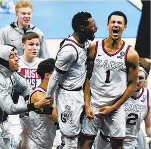  ?? MICHAEL CONROY AP ?? Gonzaga guard Jalen Suggs (1) celebrates with Joel Ayayi after making the game-winning basket against UCLA during overtime in an NCAA Tournament semifinal.