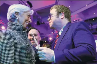  ??  ?? No business like showbusine­ss: Head of the IMF Christine Lagarde talks with Elton John, above; Theresa May, right, is due to speak at the World Economic Forum, and, below Cate Blanchett yesterday received an entreprene­urship award