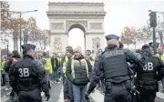  ??  ?? SYMBOLIC MARCH: Protesters wearing yellow vests block the street in Paris yesterday.
